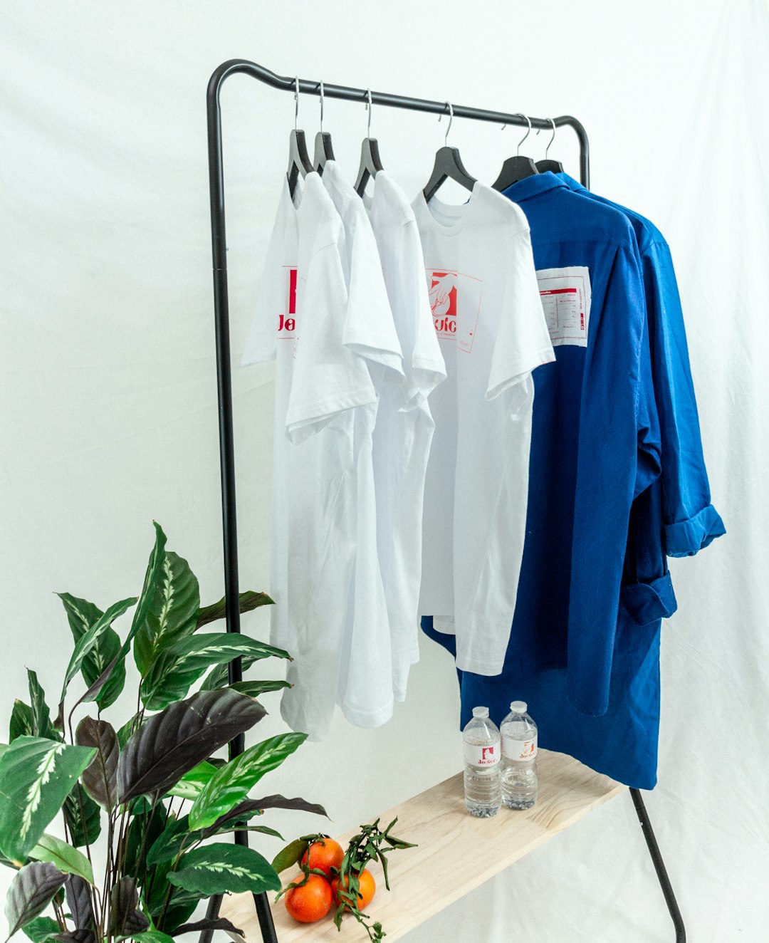 white-button-up-shirt-hanging-on-black-metal-rack-gihyefvuiw8